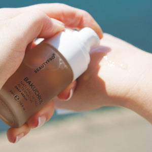 Hand holding BEAUTYPRO Bakuchiol serum pump bottle — gentle daily face serum vegan Korean skincare